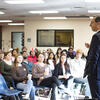 Provost Mandell speaks in front of a group of honors students.